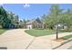 Charming brick home featuring manicured lawn and long driveway on a sunny day at 260 Bonnie Ln, Fayetteville, GA 30215