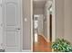 Hallway with hardwood flooring, white doors, and views into other rooms at 260 Bonnie Ln, Fayetteville, GA 30215
