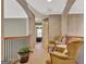 Upstairs hallway features seating area and a view into an adjacent bedroom at 260 Bonnie Ln, Fayetteville, GA 30215