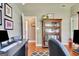 Home office featuring a hardwood floor, large bookshelf, and grey colored walls at 260 Bonnie Ln, Fayetteville, GA 30215