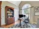 Bright home office featuring a large window, wood floors, and a built-in bookcase at 260 Bonnie Ln, Fayetteville, GA 30215