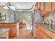 Open kitchen with granite countertops, stainless steel appliances, and wood cabinetry adjacent to dining area at 260 Bonnie Ln, Fayetteville, GA 30215