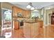 Open kitchen featuring stainless steel appliances, a center island, and wood flooring at 260 Bonnie Ln, Fayetteville, GA 30215