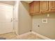 Laundry room featuring cabinetry, tile flooring, and a utility sink at 260 Bonnie Ln, Fayetteville, GA 30215