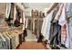 Organized walk-in closet featuring wood floors, hanging rods, and shelving at 260 Bonnie Ln, Fayetteville, GA 30215