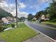 A street view of a neighborhood with well-maintained lawns and various home styles at 8519 Glenwoods Dr, Riverdale, GA 30274