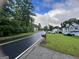 A view of a neighborhood street featuring well-kept lawns and diverse home designs at 8519 Glenwoods Dr, Riverdale, GA 30274