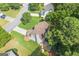 An aerial view showcasing the home's backyard, patio with firepit, and lush green landscaping at 7505 Brookwood Way, Cumming, GA 30041