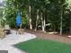 Landscaped backyard with gravel, adirondack chairs and a lush green lawn at 7505 Brookwood Way, Cumming, GA 30041