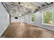 Large, finished basement with exposed ceiling, vinyl floors and natural light at 7505 Brookwood Way, Cumming, GA 30041