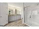 Bright bathroom showcasing double vanities, modern fixtures, and a luxurious glass shower at 7505 Brookwood Way, Cumming, GA 30041