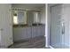 Elegant bathroom featuring dual vanities with granite countertops and a glass-enclosed shower at 7505 Brookwood Way, Cumming, GA 30041