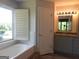 Bright bathroom showcasing a soaking tub, granite countertop vanity and window with shutter at 7505 Brookwood Way, Cumming, GA 30041
