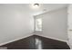 Bedroom with hardwood floors and a window providing natural light at 7505 Brookwood Way, Cumming, GA 30041