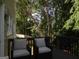 Relaxing outdoor deck space with comfortable seating surrounded by a tranquil wooded view at 7505 Brookwood Way, Cumming, GA 30041