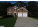 Beautiful two-story brick home with a two-car garage and a well-manicured lawn at 7505 Brookwood Way, Cumming, GA 30041