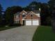 Charming two-story brick home with a two-car garage and a well-maintained lawn at 7505 Brookwood Way, Cumming, GA 30041