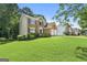 Beautiful two-story home with manicured lawn, two-car garage, and lush landscaping at 7505 Brookwood Way, Cumming, GA 30041
