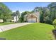 Beautiful brick front home with a well-manicured lawn and a large driveway at 7505 Brookwood Way, Cumming, GA 30041