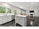 Bright, updated kitchen with stainless steel appliances, an island, and dark hardwood floors at 7505 Brookwood Way, Cumming, GA 30041