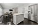 Spacious kitchen with stainless steel appliances, center island, and an adjacent dining area at 7505 Brookwood Way, Cumming, GA 30041