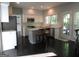 Modern kitchen featuring white cabinets, stainless steel appliances, and a center island with seating at 7505 Brookwood Way, Cumming, GA 30041
