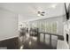 Open-concept living space with dark wood floors, natural light, and a view of the modern kitchen at 7505 Brookwood Way, Cumming, GA 30041