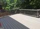 Spacious backyard deck with wooden railings, providing a relaxing outdoor space surrounded by trees at 522 Blue Mountain Rise, Canton, GA 30114