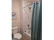 Clean, tiled bathroom with a combined shower and tub, plus updated fixtures and plenty of natural light at 522 Blue Mountain Rise, Canton, GA 30114