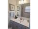 Bathroom with a white vanity, a gold faucet, decorative towels, and an orchid at 522 Blue Mountain Rise, Canton, GA 30114