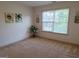 Carpeted bedroom with a window, -themed artwork, and neutral color scheme at 522 Blue Mountain Rise, Canton, GA 30114