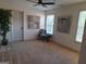 Bedroom with carpet, fan, and natural light; features artwork and a chair with pillows at 522 Blue Mountain Rise, Canton, GA 30114