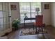 Bright home office featuring a desk in front of a window, an orange chair, and french doors at 522 Blue Mountain Rise, Canton, GA 30114