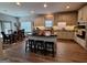 Bright, open kitchen with island seating, stainless appliances, and adjacent dining area at 522 Blue Mountain Rise, Canton, GA 30114
