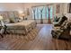 Inviting main bedroom with hardwood floors, large windows, and a cozy seating area at 522 Blue Mountain Rise, Canton, GA 30114