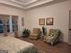 Spacious main bedroom offers hardwood floors, comfortable seating area, and natural light at 522 Blue Mountain Rise, Canton, GA 30114