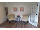 Cozy sitting area with two patterned chairs, a glass table, artwork, and french doors at 522 Blue Mountain Rise, Canton, GA 30114