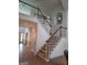 Elegant staircase with dark wood railings, carpeted steps, and bright, open landing at 522 Blue Mountain Rise, Canton, GA 30114