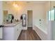 This bathroom features a dual sink vanity, tile flooring, soaking tub and decorative lighting at 40 Westbrook Rd, Carrollton, GA 30116
