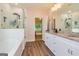 This bathroom features dual vanities with granite countertops, glass enclosed shower and a soaking tub at 40 Westbrook Rd, Carrollton, GA 30116