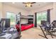 Comfortable bedroom with a bunk bed, two windows, and a gaming setup at 40 Westbrook Rd, Carrollton, GA 30116
