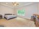 Cozy bedroom with neutral carpet, ceiling fan and large window overlooking the outdoor scenery at 40 Westbrook Rd, Carrollton, GA 30116