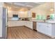 Bright kitchen featuring white cabinets, granite countertops, and stainless steel appliances at 40 Westbrook Rd, Carrollton, GA 30116