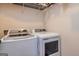Efficient laundry room with modern washer and dryer units and shelving at 40 Westbrook Rd, Carrollton, GA 30116