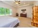 This main bedroom features natural lighting from a large window, tray ceilings, and neutral colored walls at 40 Westbrook Rd, Carrollton, GA 30116