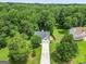 Aerial view of a home with mature trees, a large lot, and a well-manicured lawn at 52 Cherub Ln, Sharpsburg, GA 30277