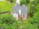 An aerial view of the home's roof, backyard, and deck surrounded by lush, mature trees providing natural shade at 52 Cherub Ln, Sharpsburg, GA 30277
