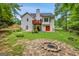 Backyard features a firepit and a two-story home with a deck, perfect for outdoor gatherings at 52 Cherub Ln, Sharpsburg, GA 30277