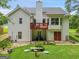 Well-maintained backyard featuring a deck, manicured lawn, and lush landscaping at 52 Cherub Ln, Sharpsburg, GA 30277