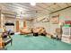 Finished basement with neutral-toned walls, green carpeting, and a lounge area with two couches at 52 Cherub Ln, Sharpsburg, GA 30277